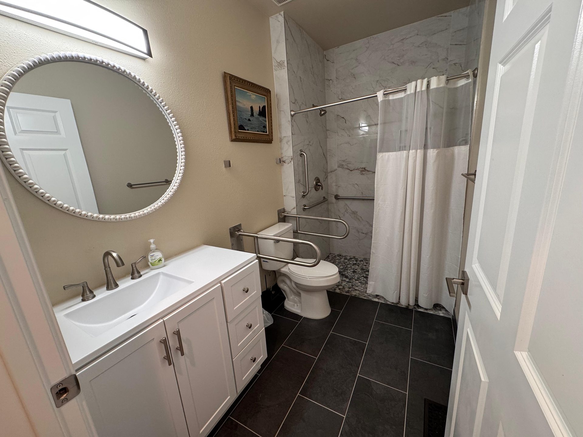 Accessible bathroom with grab bars and roll-in shower